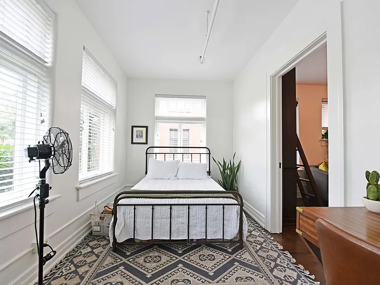 Bedroom with hardwood-style flooring