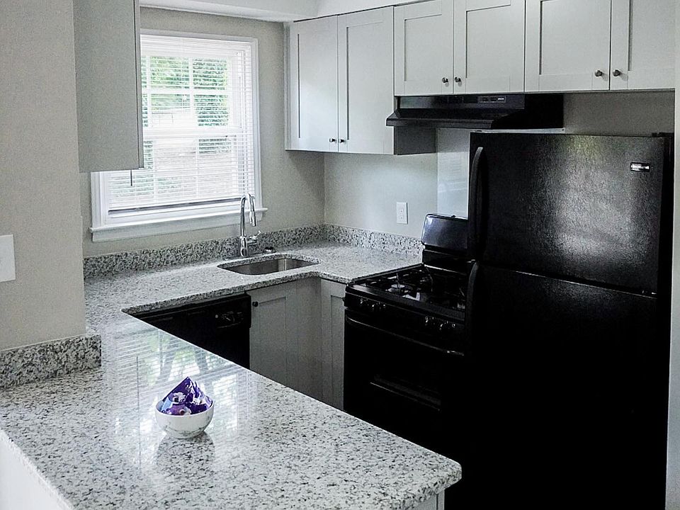 Fully renovated kitchen with granite countertops, upgraded appliances, and painted wood cabinetry