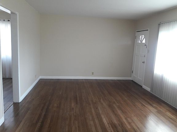LARGE Living room with newly refinished hard wood floors.