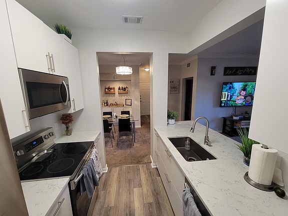 Open Kitchen with views of the dining room, entry, living room, and patio.
