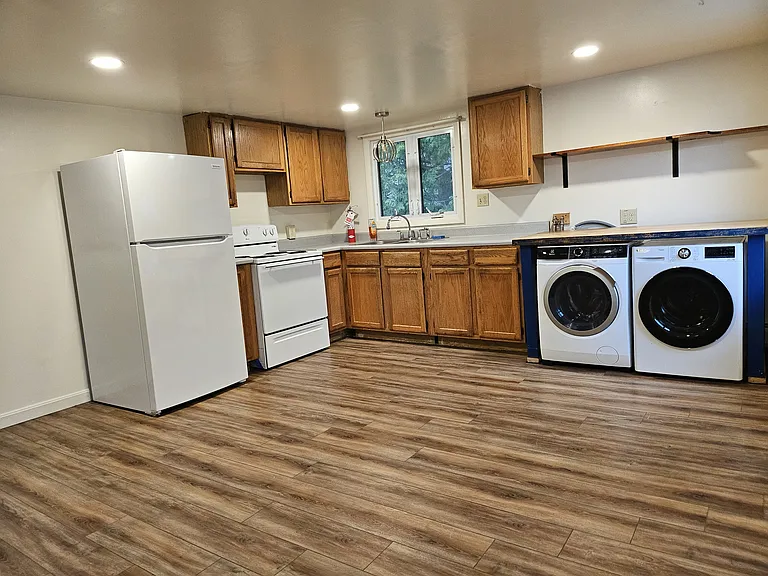 Kitchen with electric range and laundry