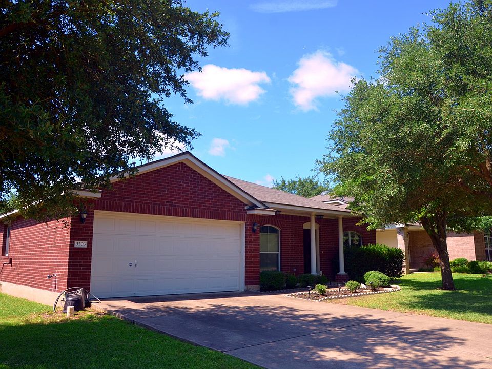 Front, 2 car Garage. Cute Porch Area. Two oak trees.