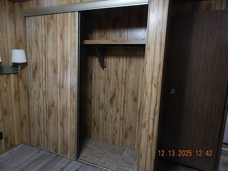 Closet--middle bedroom - notice reading lamp on wall.