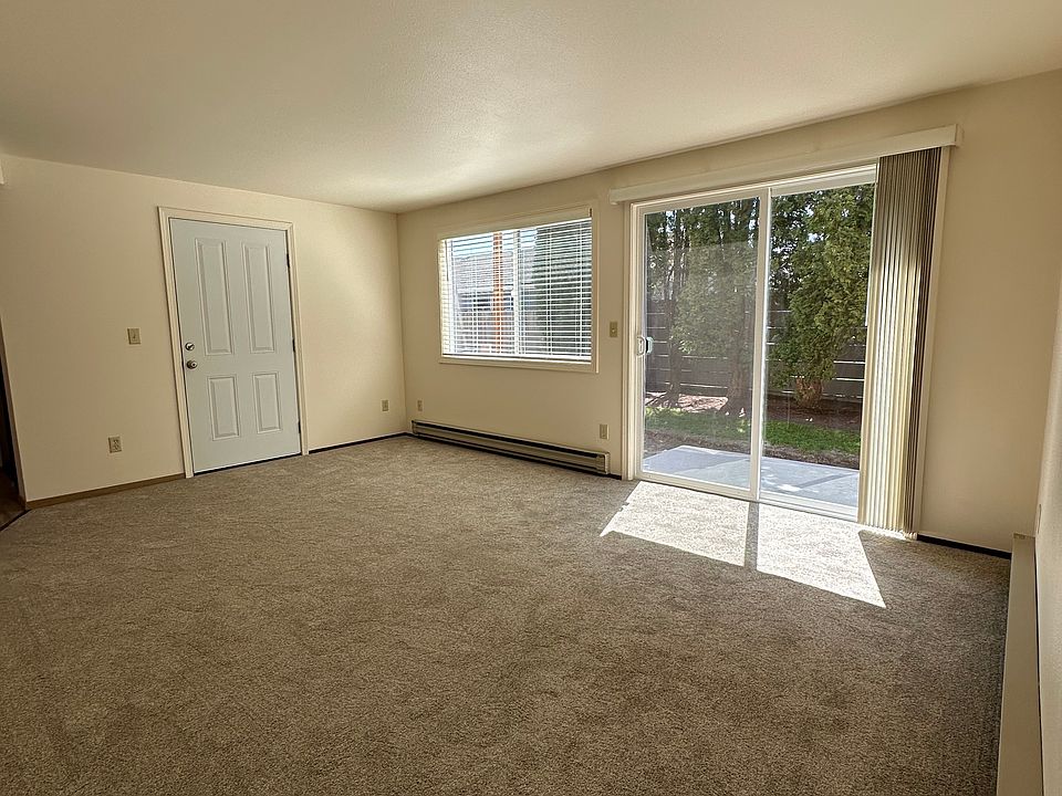 Living room has an outdoor patio with new concrete.