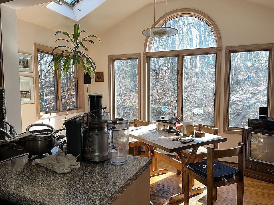 Kitchen looks out over acre