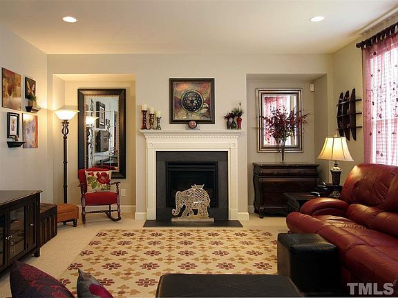 Cozy gas-log fireplace is the focal point of the spacious great room. Recessed niches flank the fireplace.