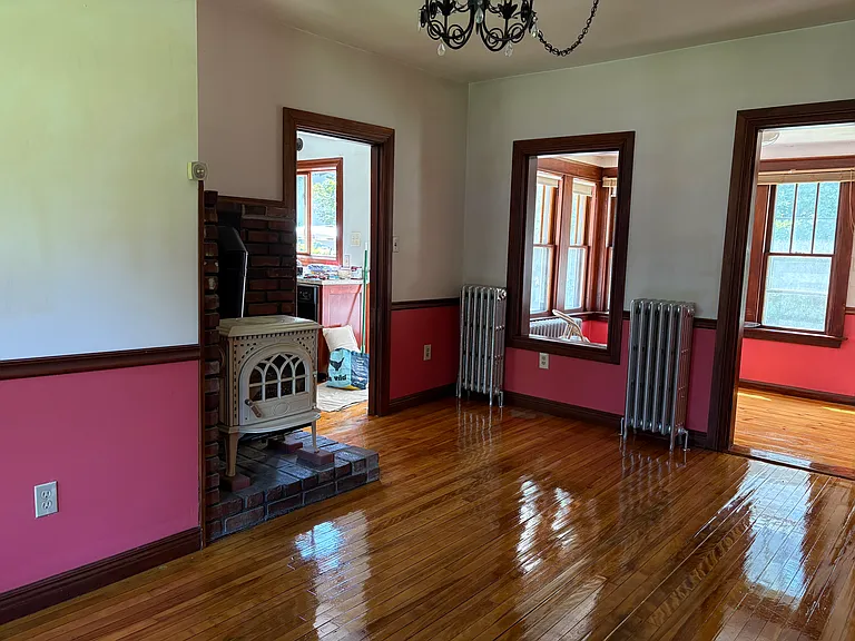 Living room/ dining room looking into kitchen and sunroom.