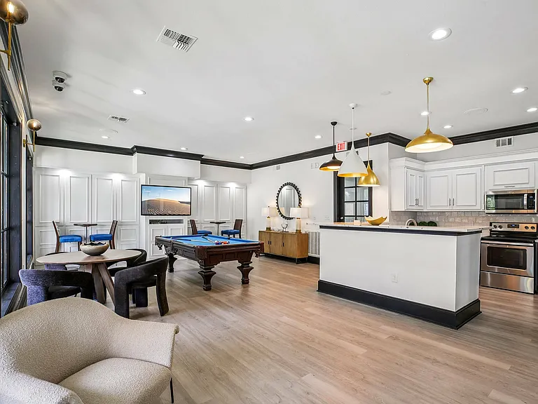 Enjoy the resident gaming lounge at Providence Uptown with media entertainment, cozy seating, and social spaces.