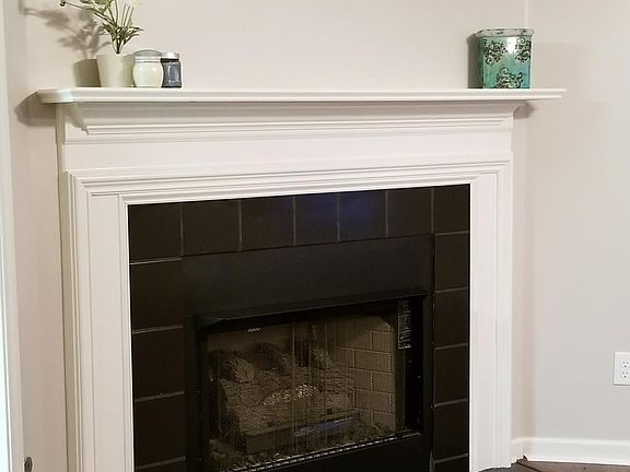 Lovely gas fireplace and mantel in living room