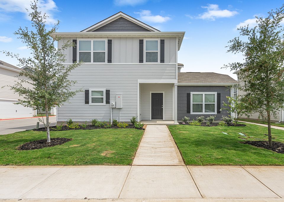 Exterior of the Reynard, featuring professional front yard landscaping.