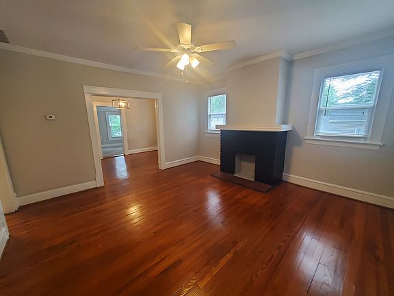 another view of the large living room separate of the dining room and back den / office
