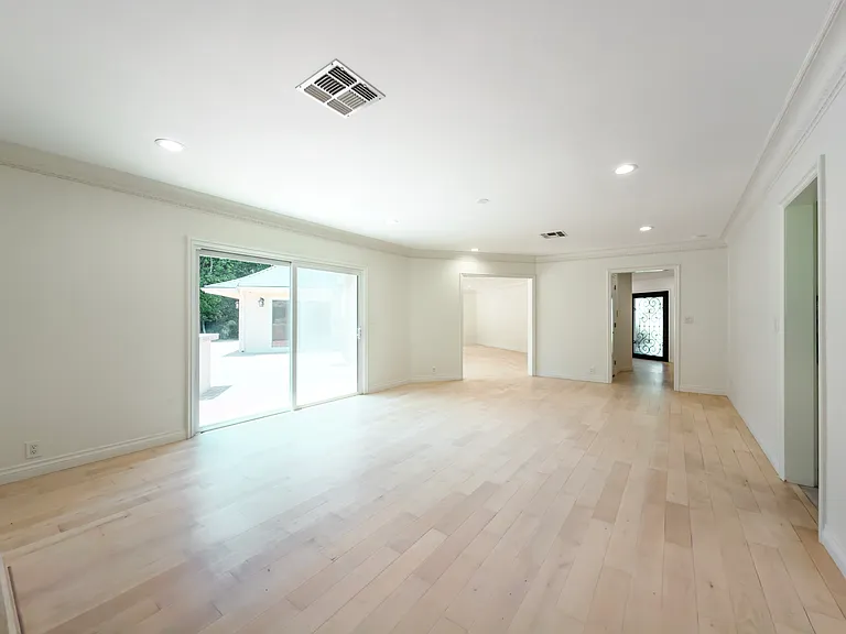 Airy unfurnished dining space with sliding glass door access to the patio suits al fresco living in this Beverly Hills luxury rental at 1094 Garden Lane, 90210.