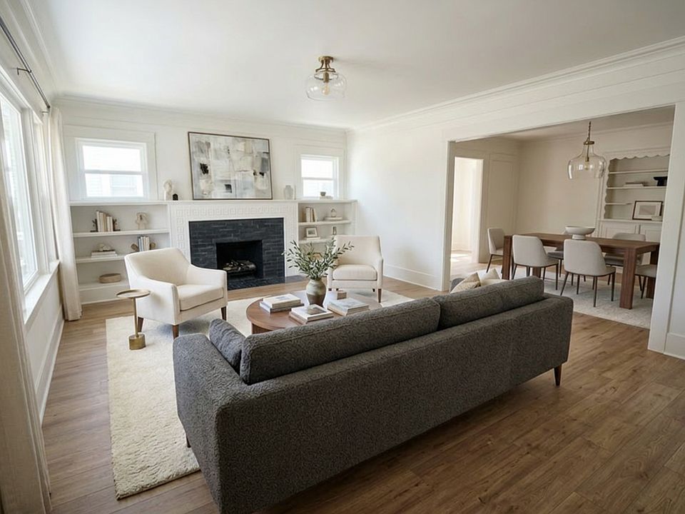 Large Living Room with built-in book shelves and fireplace with gas appliance. Virtual Staging