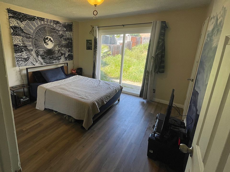 Your spacious future room (make the bed look small), newer vinyl flooring, sliding door opens into huge backyard!