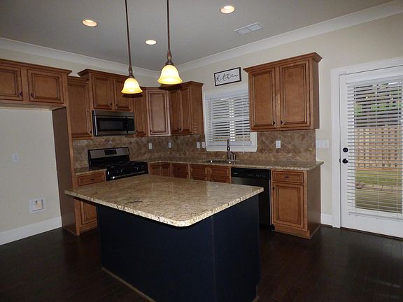 Granite counters and tile backsplash plus wood floors