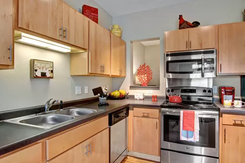 Covington Kitchen with Stainless Steel Appliances - The Covington Apartment Homes