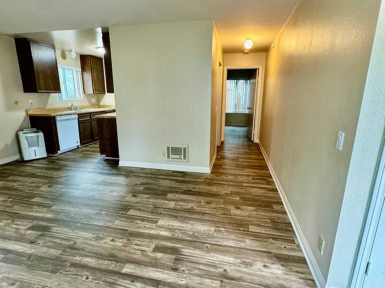 View from living room into kitchen and hallway to bedroom