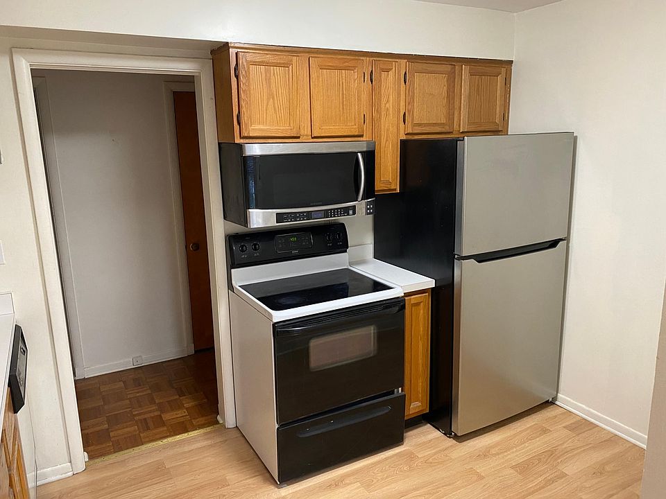 Kitchen with new fridge, glass top stove and microwave. Also exhaust fan to outside.