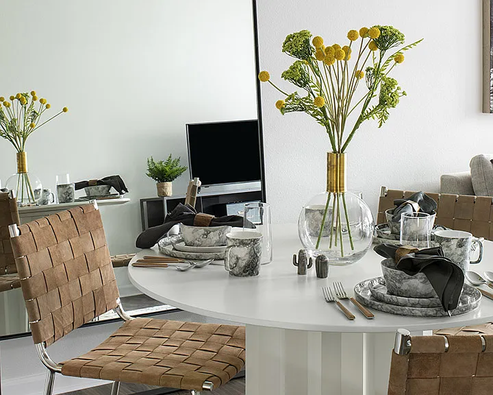Apartment dining room with wood-style flooring.