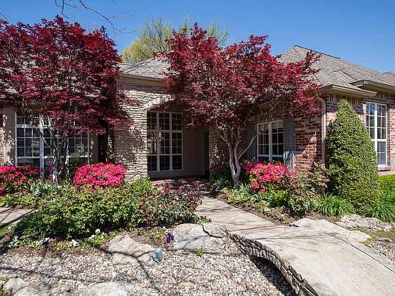 Incredible curb appeal showcasing meticulously maintained landscaping, idyllic walkways and extended patios meandering throughout the lush private lot that is the largest in the neighborhood! 