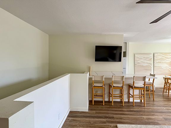 Living room with stairs to bedrooms on the left.