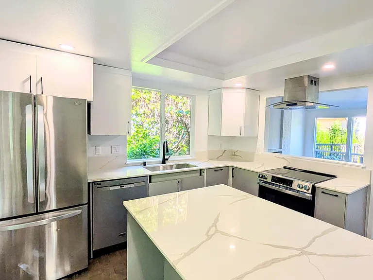 Kitchen opened up to living room and dining areas
