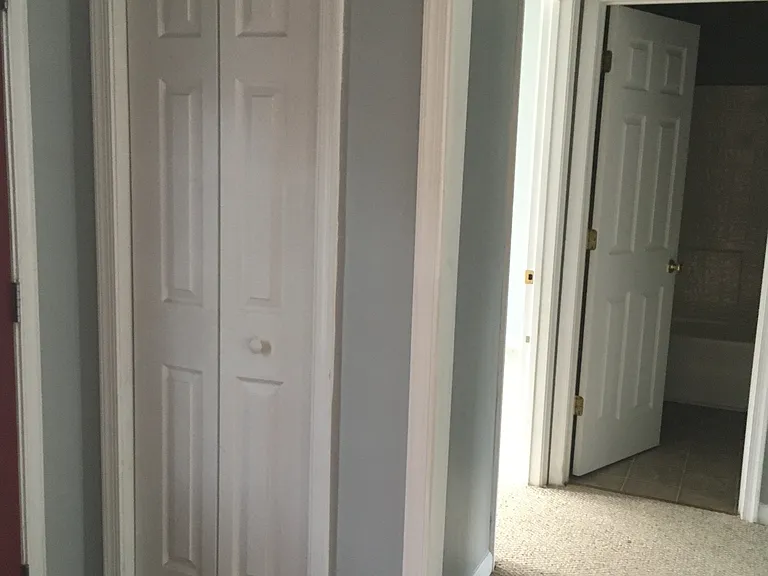 Carpeted hallway to two bedrooms and hall bathroom.