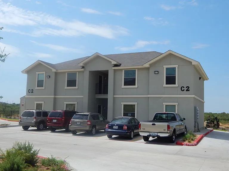Exterior Apartment Buildings with Parked Cars and Trucks View