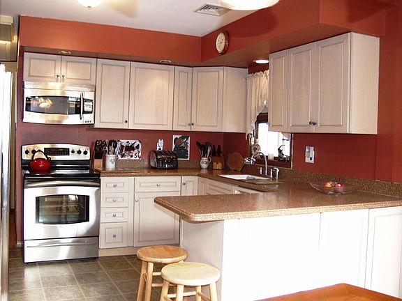 Beautifully updated kitchen with corian and stainless appliances