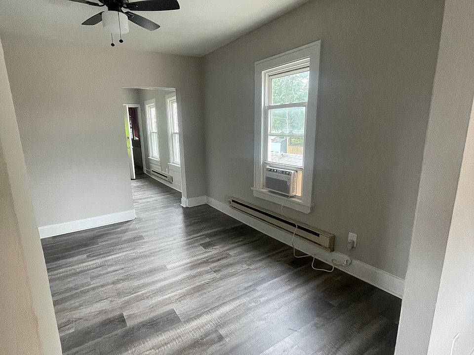New paint, flooring and ceiling fans in the dining room. Photo taken from living room and looking towards kitchen.