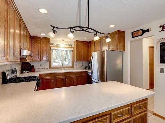 Kitchen with stainless appliances and breakfast bar
