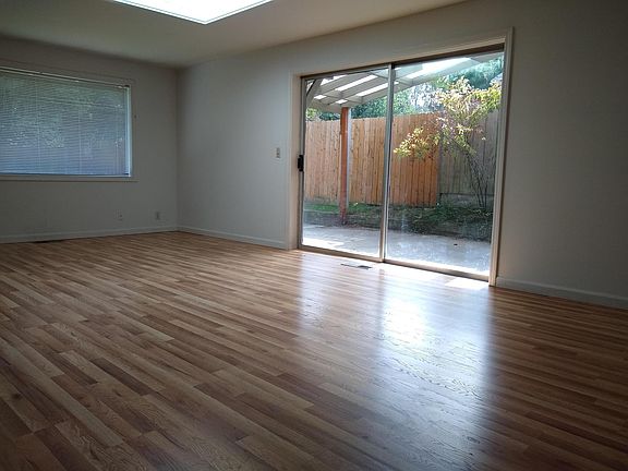 Family & dinning room walkout to covered porch in backyard