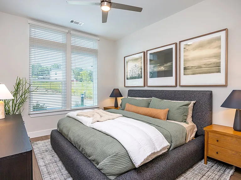 Primary bedroom with ceiling fan and hard surface vinyl plank flooring