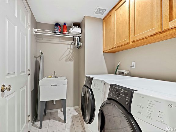 Laundry room with tub sink. Garage is through the door on the left. 