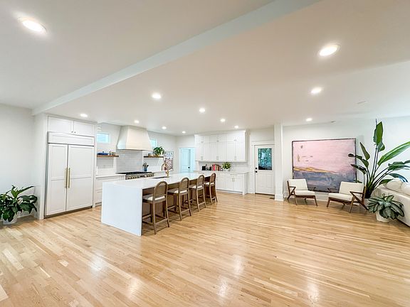 Bright and spacious, the open ground floor connects kitchen, dining, and living zones with ease. The large island anchors the layout with function and style.