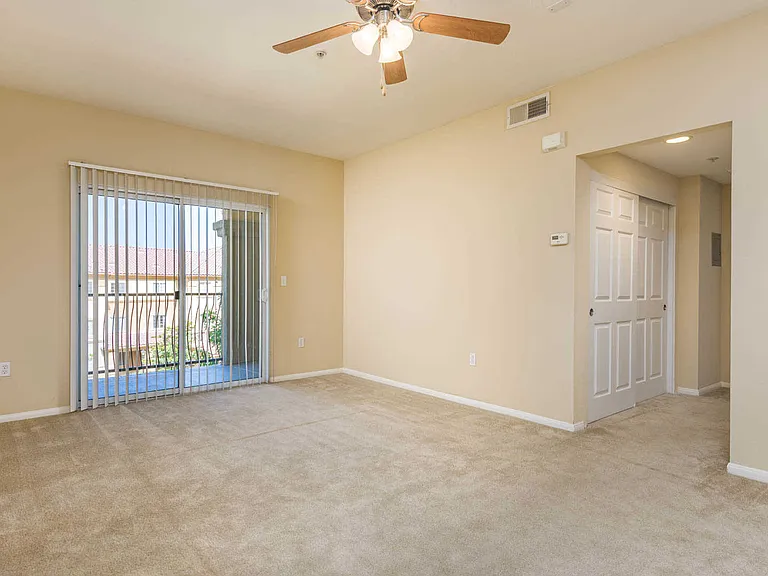 Carpeted Living Room with Balcony