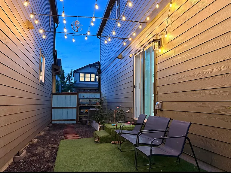 Cozy evening patio with warm string lights, inviting setup ideal for small gatherings or outdoor parties.