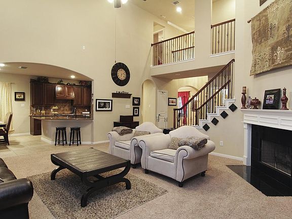 Living Room 2 - Look at this beautiful view of the wrought iron stair case! Gorgeous archways & completely open! This room is where families come together!