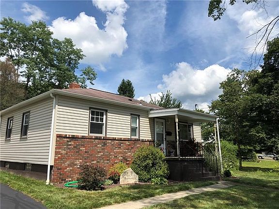 Beautifully maintained yard with covered front entrance