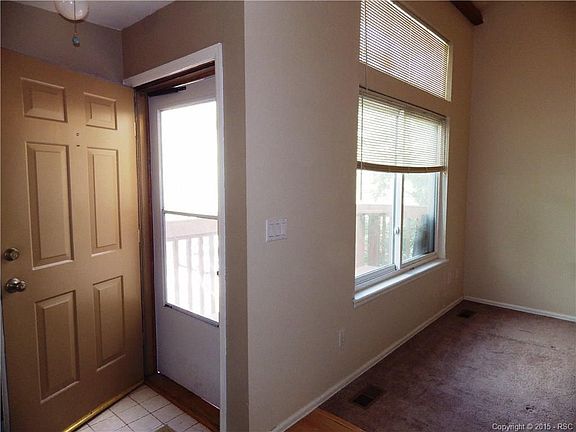Entry way and large windows in living room.