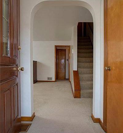 THE ENTRY LEADS INTO LIVING ROOM AND KITCHEN WITH EASY ACCESS TO THE UPSTAIRS.