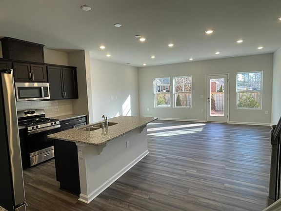 Living room and kitchen - Lots of natural light from outside. Other side has a big coat closet and half bath