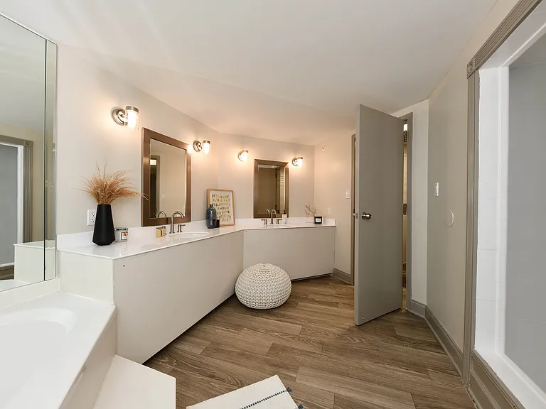 Bright bathroom with quartz counters and double vanity