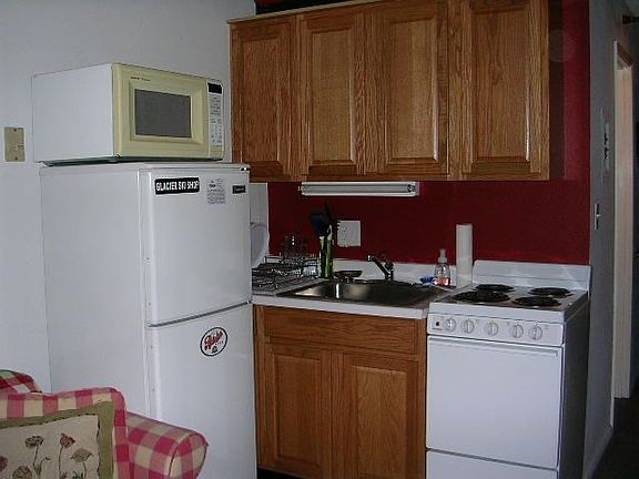 Kitchen area with new cabinets, countertops, fixtures, and appliances.