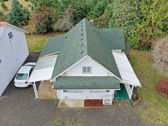 Aerial view of the house, East side. Note both parking spaces visible. Front and back garden visible.