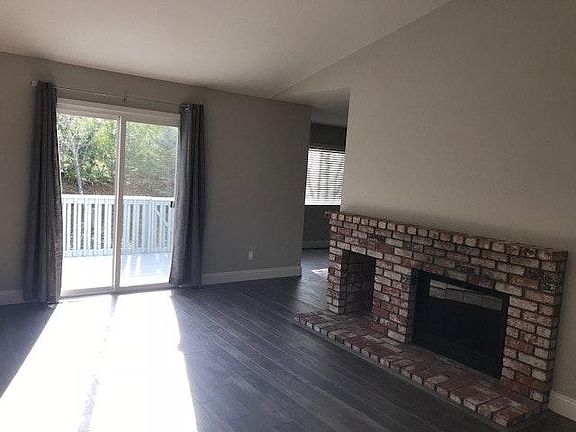 Living Rooom with fireplace and slider to deck