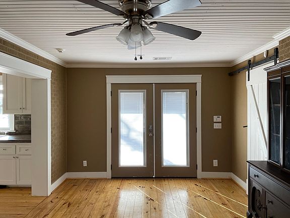 Extra room looking towards kitchen and front French doors