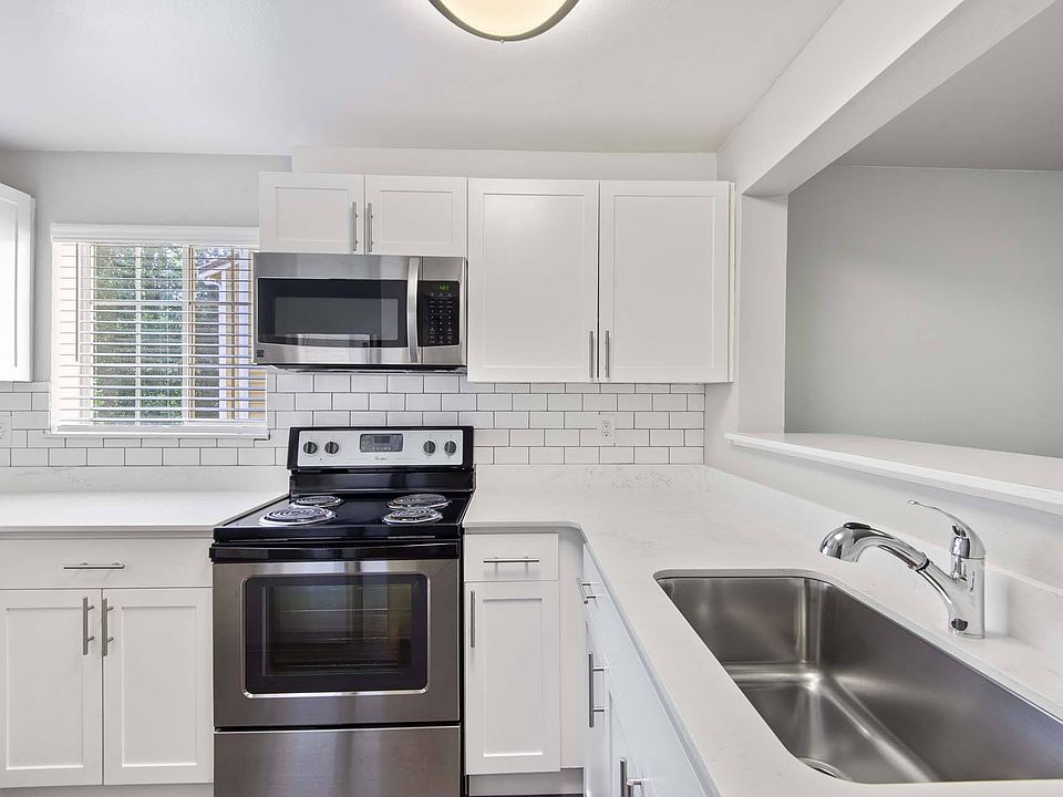 Prepare your favorite meals in a sleek, modern kitchen featuring stainless steel appliances and clean, contemporary finishes.