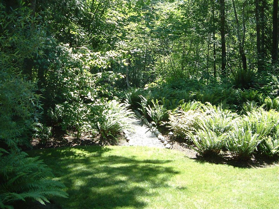 Follow a path from the manicured backyard to your own private riverfront beach