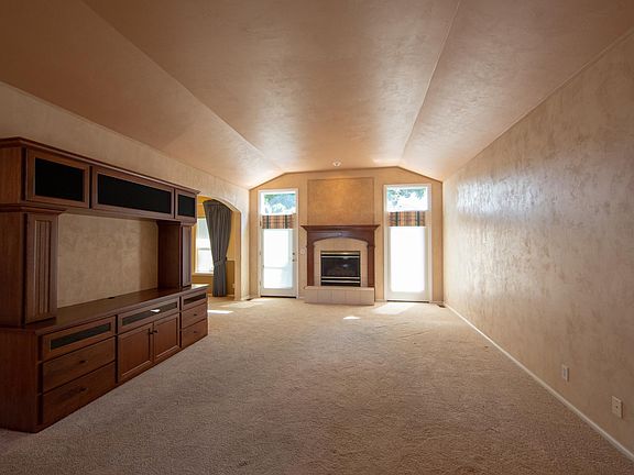 Main living room with gas fireplace and built in entertainme